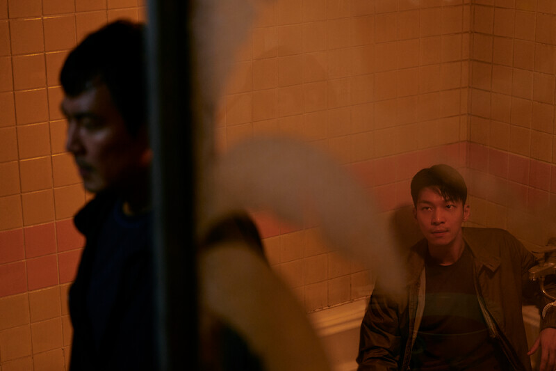 A man handcuffed in to a faucet sits in a bath tub Season 2 of 'Squid Game'