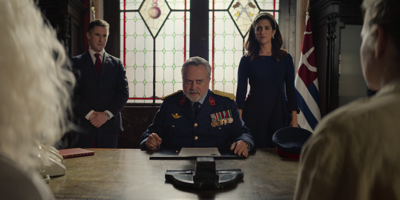 Stanley Townsend as Minos sits at a desk wearing a military uniform in Season 1 of ‘Kaos’