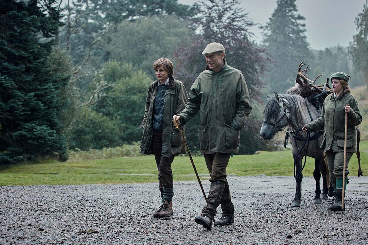 Lady Diana Spencer Visits Balmoral walking in front of a horse carrying a deer. 