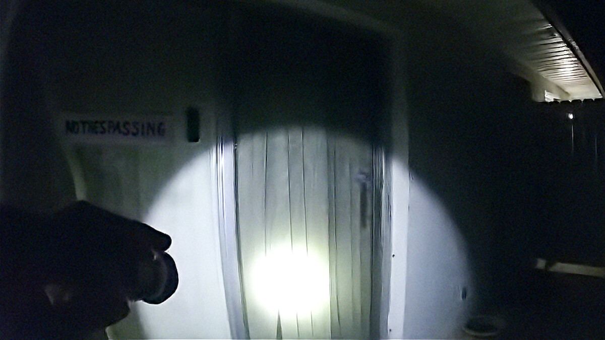 Body cam footage of flashlight on a door