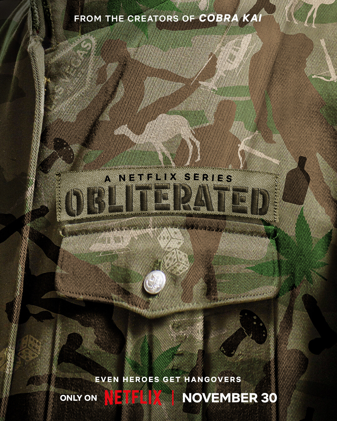 An army uniform with icons of mushrooms, camels, dice, and more embedded into the camouflage print with the word “Obliterated” embroidered above the pocket.