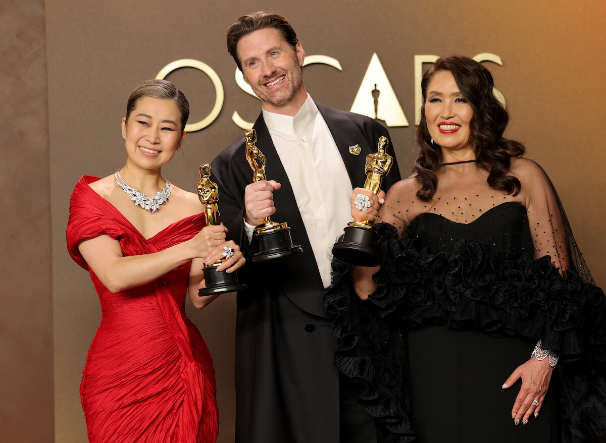 (L-R) Maggie Kang, Chris Appelhans, and Michelle L.M. Wong, winners of the Best Animated Feature Film Award for “KPop Demon Hunters”, pose in the press room during the 98th Oscars at Dolby Theatre on March 15, 2026 in Hollywood, California.