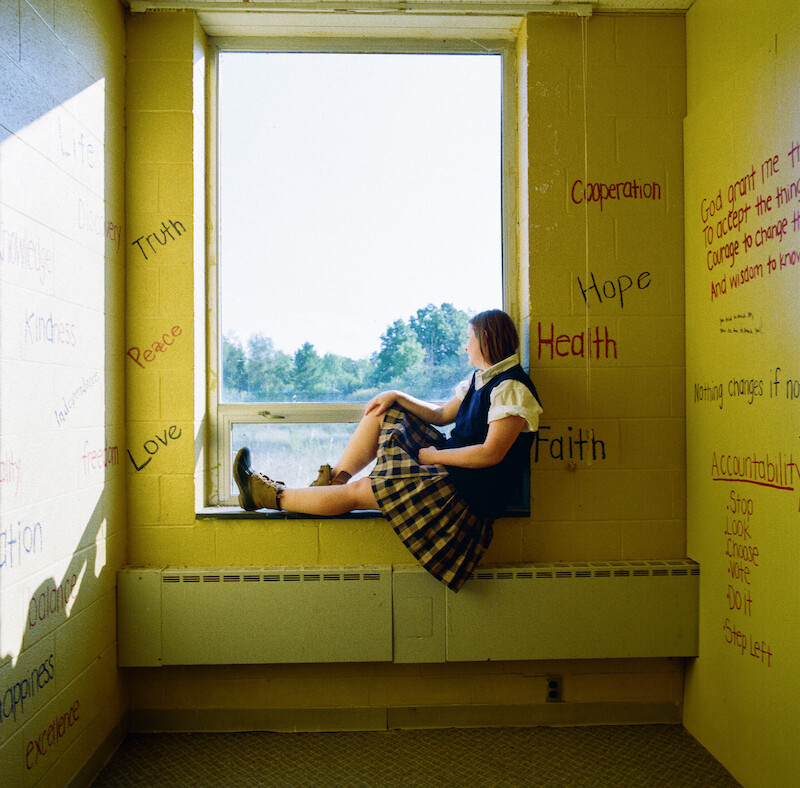 Katherine Kubler sitting in the window at Ivy Ridge. 