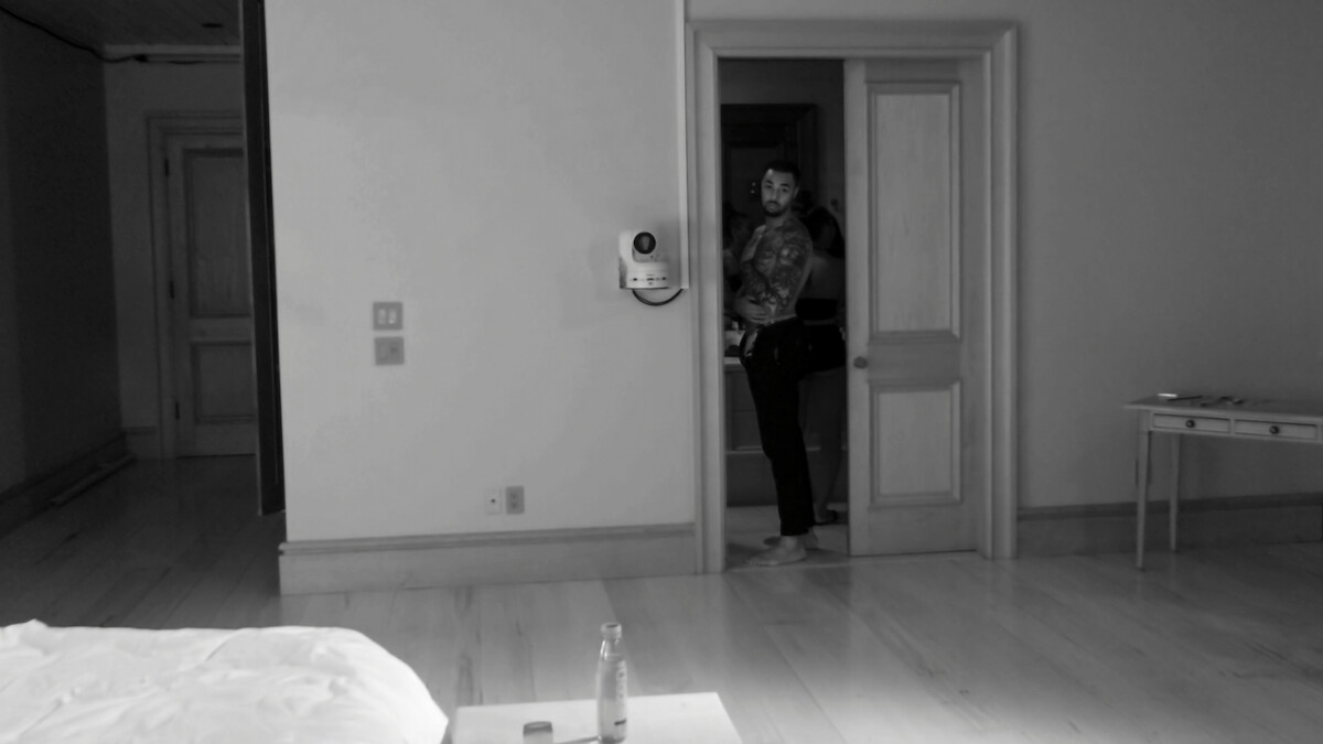 A night-vision shot of Brion looking out from the bathroom.