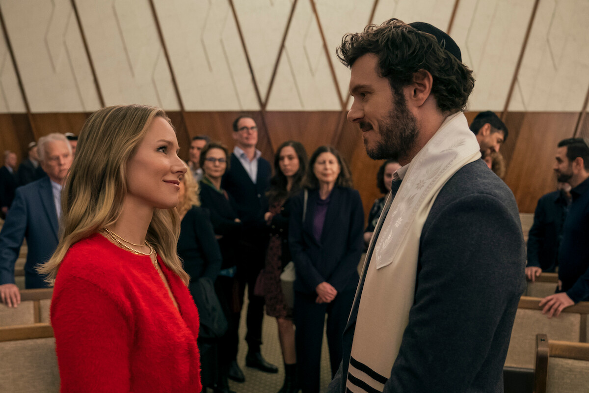Kristen Bell as Joanne and Adam Brody as Noah face each other smiling in Season 1 of ‘Nobody Wants This’