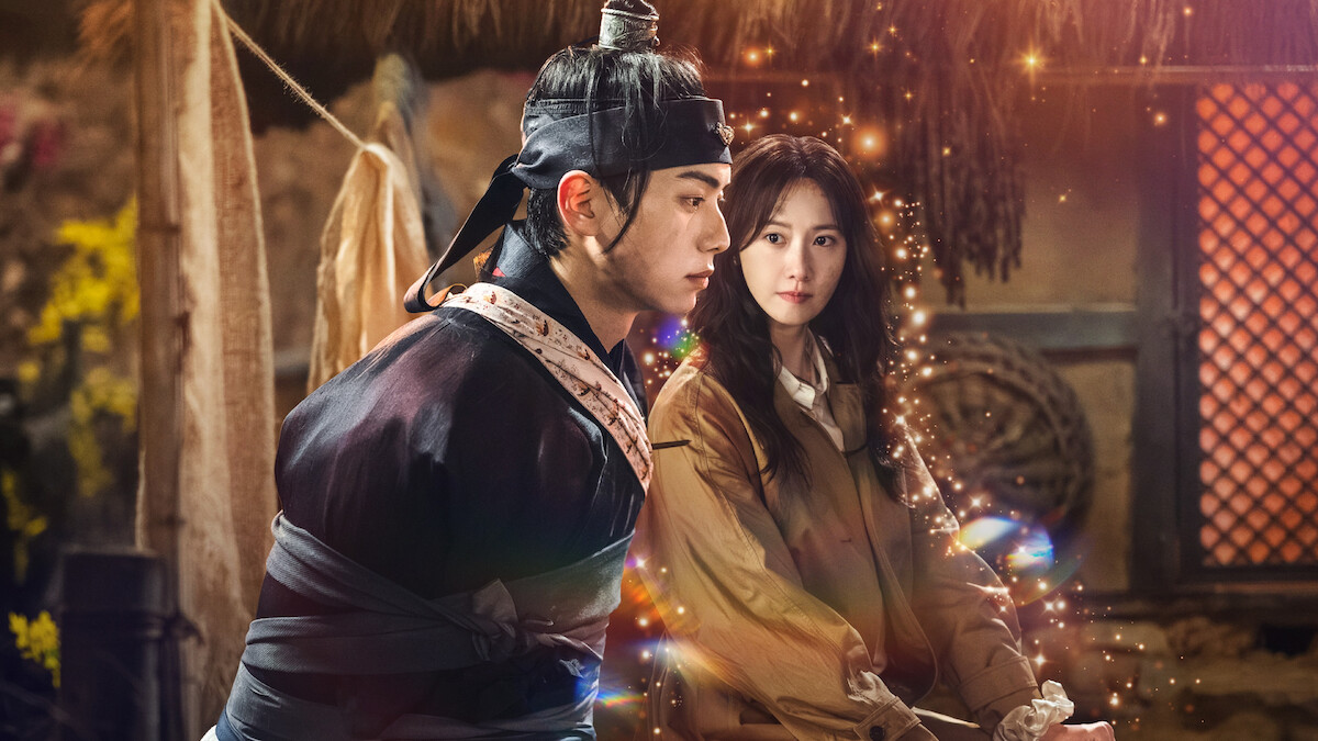 Lim Yoon-a as Yeon Ji-young and Lee Chae-min as King Yi Heon about to slip through time in a production still from ‘Bon Appétit, Your Majesty.’