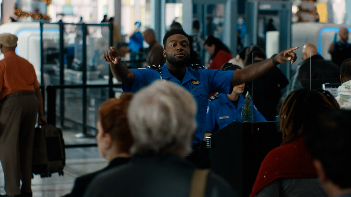 TSA Officer directing people in an airport.