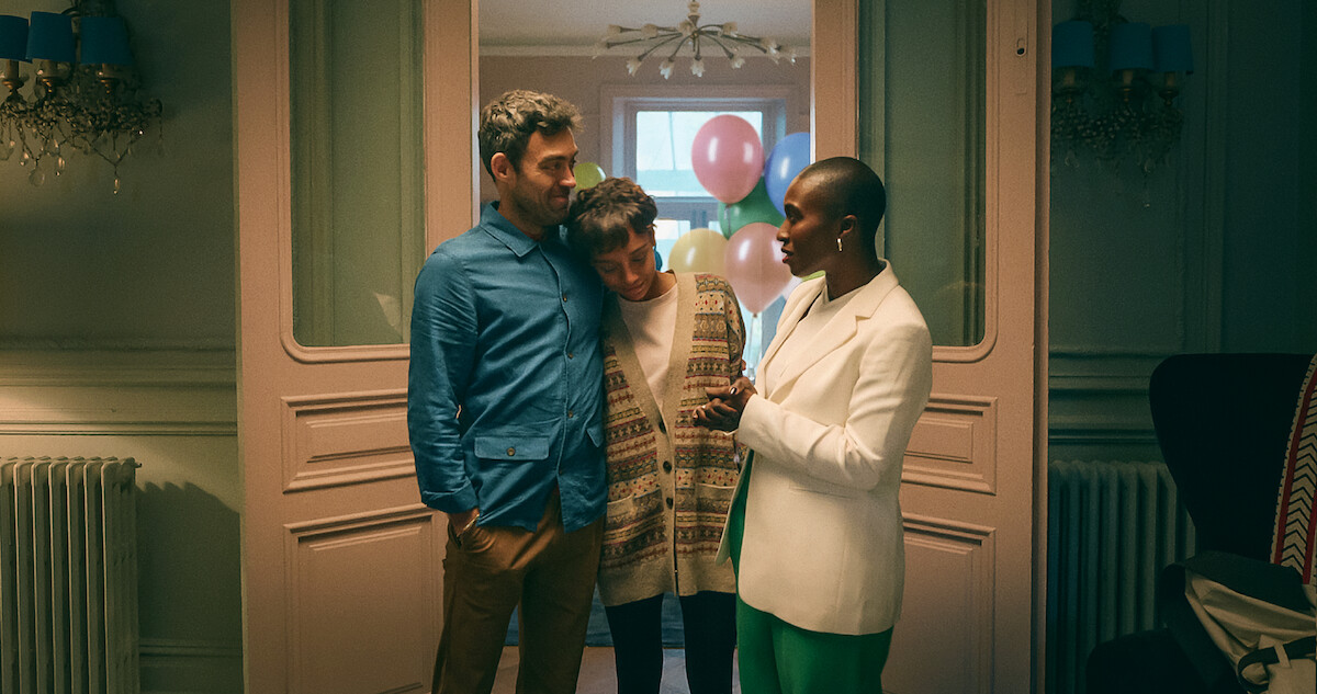 Alex Hassell as Rick, Sophie Wilde as Mia, and Vivienne Acheampong as Viv embrace each other in ‘Everything Now.’