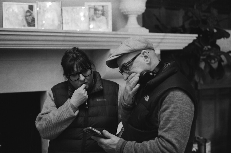 Black-and-white image of the crew working together in Season 1 of 'Fool Me Once'