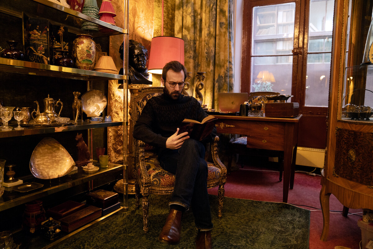 Antoine Gouy as Benjamin sits in an office in Season 3 of ‘Lupin.’