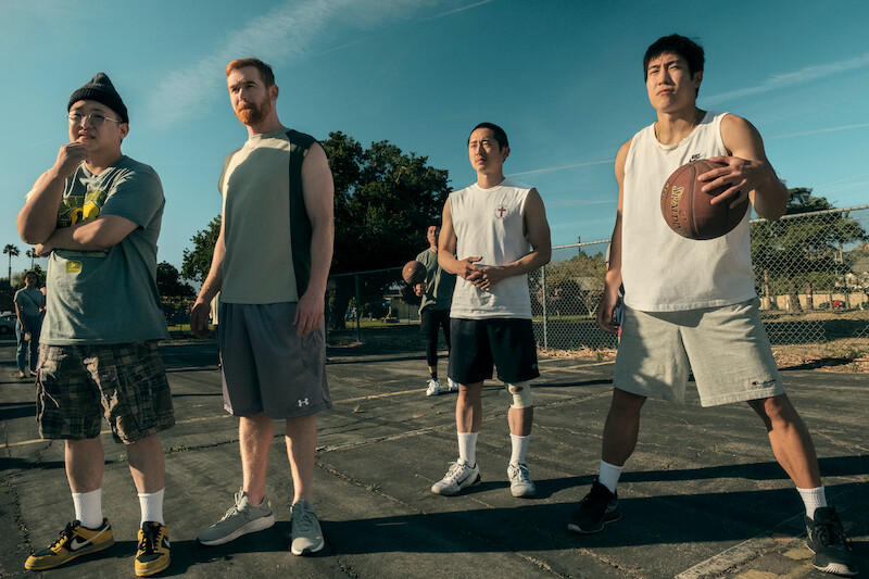 four men playing basketball