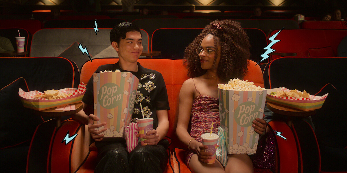 Will Gao as Tao and Yasmin Finney as Elle sit together in a movie theater in Season 2 of ‘Heartstopper.’