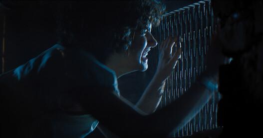 A terrified Melody peeks through a grate to get away