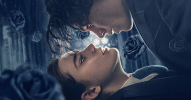 Two lovers look into each other's eyes with black roses falling around them in 'The Tearsmith.'