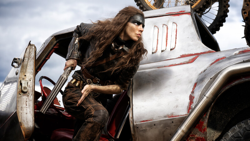 Anya Taylor-Joy as Furiosa getting out of car with shotgun