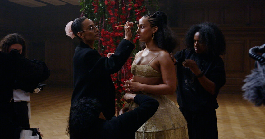 Alicia Keys stands as her makeup is done 