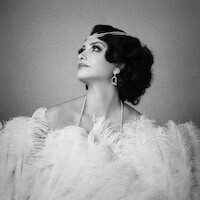 Black and white photo of Penélope Cruz in character as Néne Romero in La Bola Negra