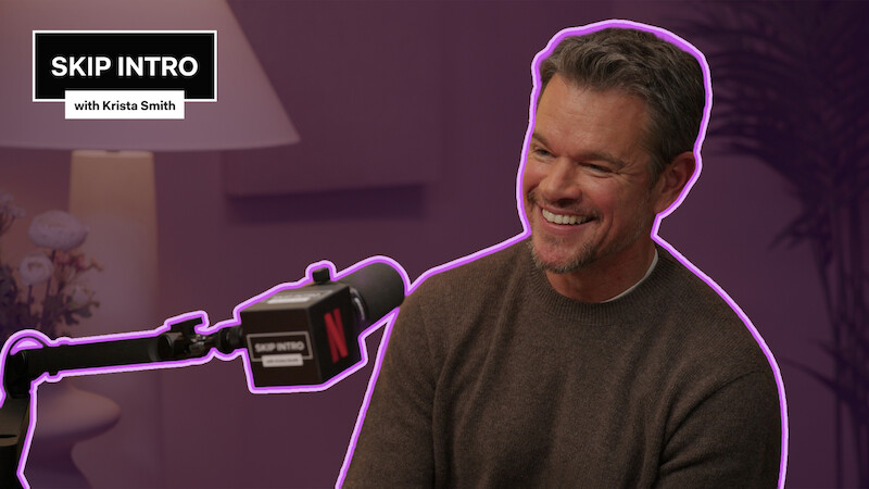 Matt Damon sits smiling in front of a microphone during a podcast recording for "Skip Intro with Krista Smith." The background is purple, and the podcast logo appears in the top left corner.