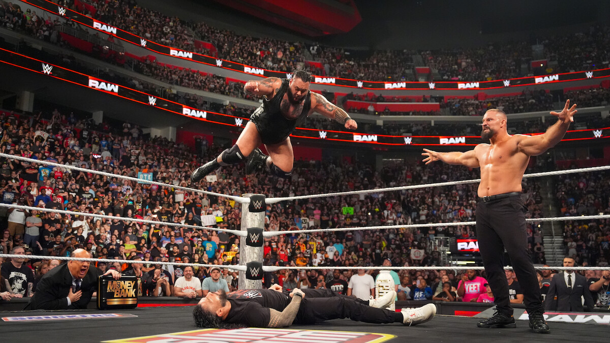 Bronson Reed comes down with a Tsunami to Roman Reigns while Bron Breakker looks on during Monday Night RAW at Little Caesars Arena on July 28, 2025 in Detroit, Michigan