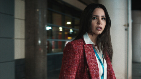 Sofia Carson in red blazer looking distressed.
