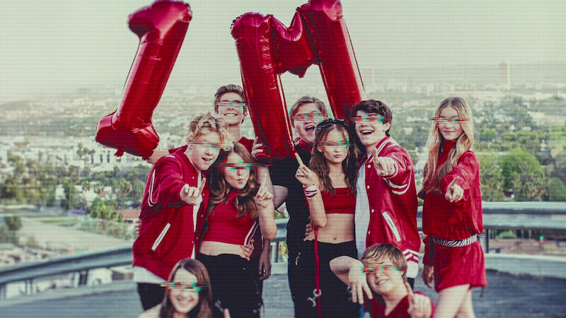 Kidfluencers pose with balloons that say 1M