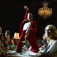 Zoe Saldaña strikes a pose on top of a table while performing the standout song from the film, "El Mal."