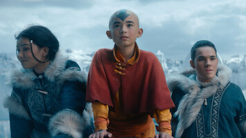 Three young children stand together in an arctic setting.