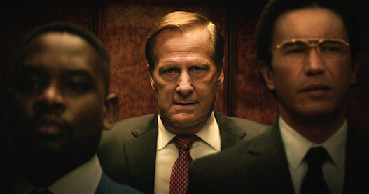 Jeff Daniels as Charlie Crocker stands in an elevator with an angry expression in 'A Man in Full'