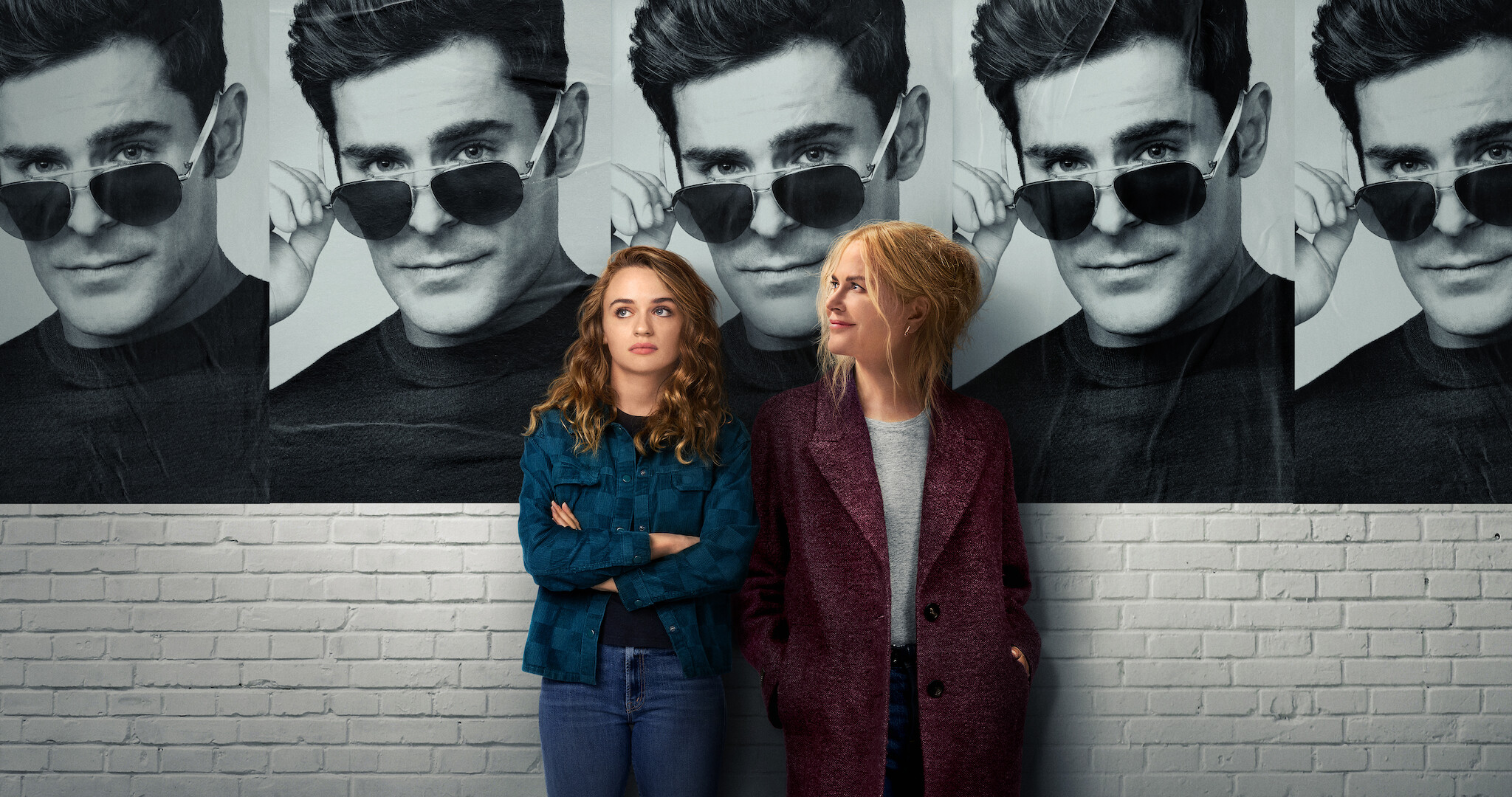 Nicole kidman, Joey King standing in front of a poster of Zach Efron