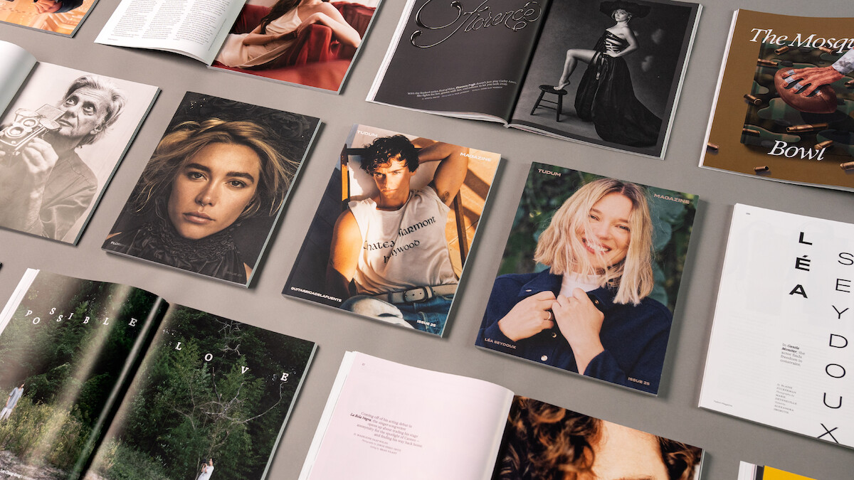 An overhead grid of Issue 25 covers and open spreads of the magazine on a warm gray background.
