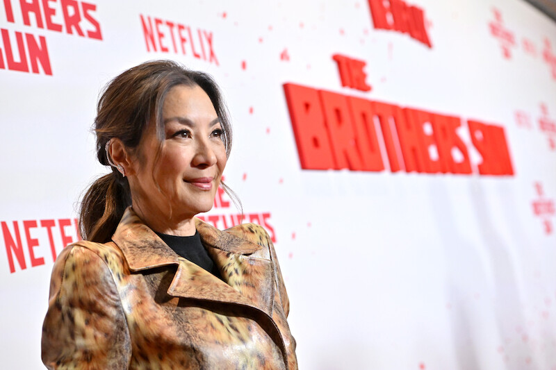 Michelle Yeoh attends Netflix's The Brothers Sun Los Angeles Premiere at Netflix Tudum Theater wearing a gold dress