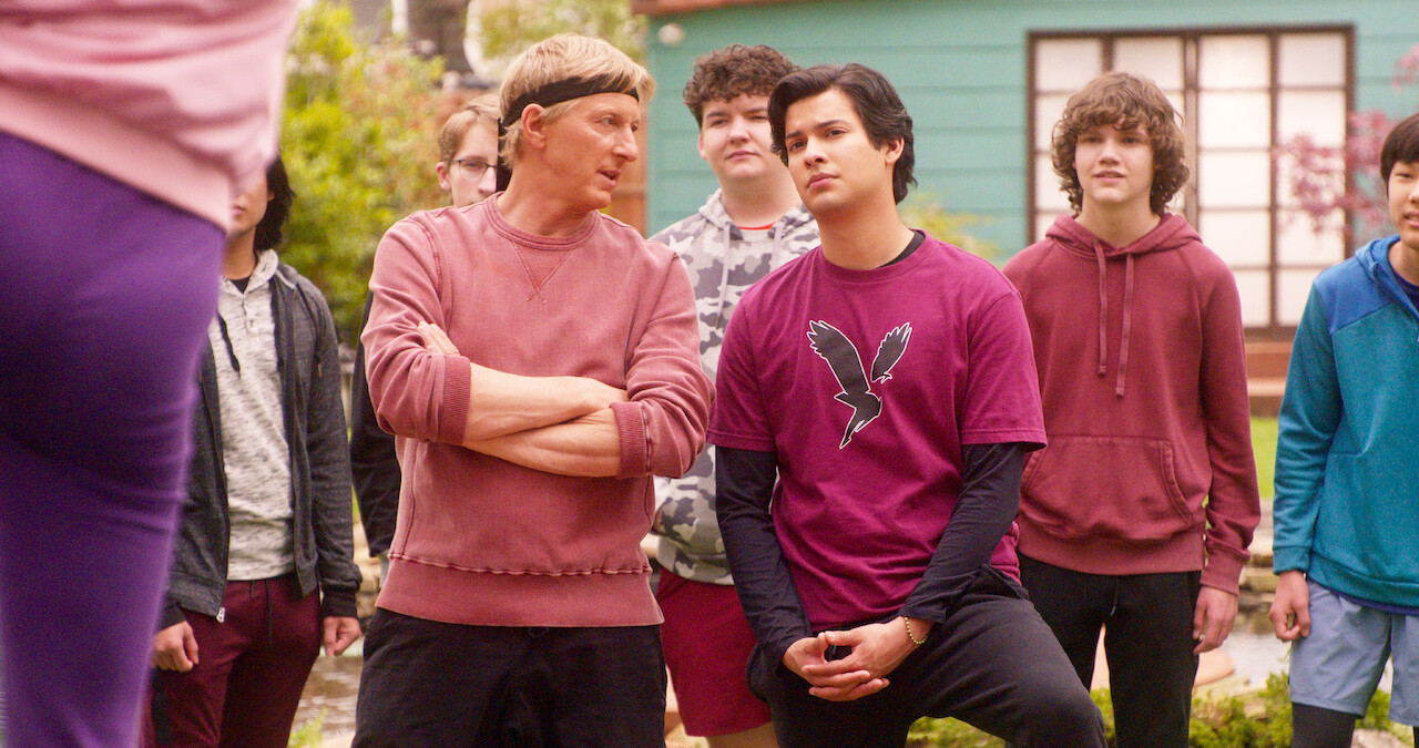 Johnny Lawrence standing beside student