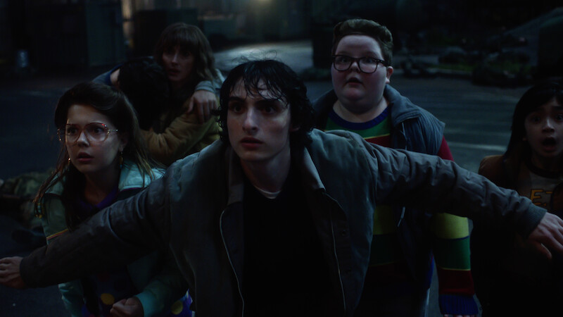 Winona Ryder as Joyce Byers, Finn Wolfhard as Mike Wheeler and Jake Connelly as Derek in 'Stranger Things 5'