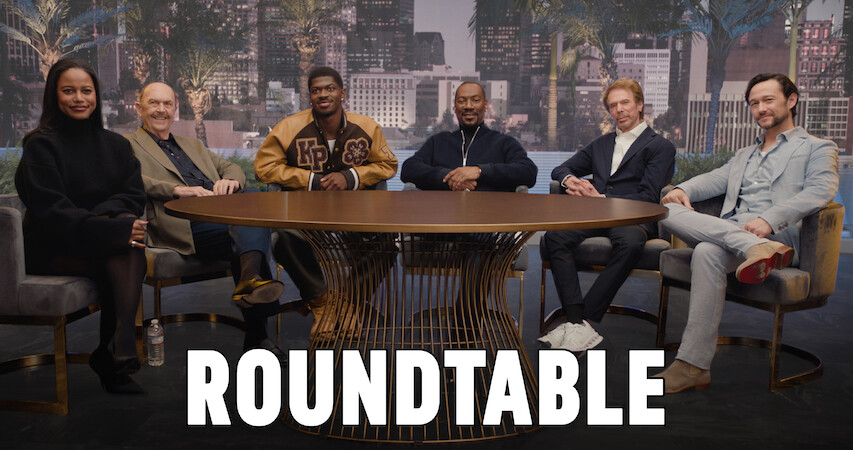 Taylour Paige, John Ashton, Lil Nas X, Eddie Murphy, Joseph "Beverly Hills: Axel F", Jerry Bruckheimer, and Lil Nas X sit around a table. 