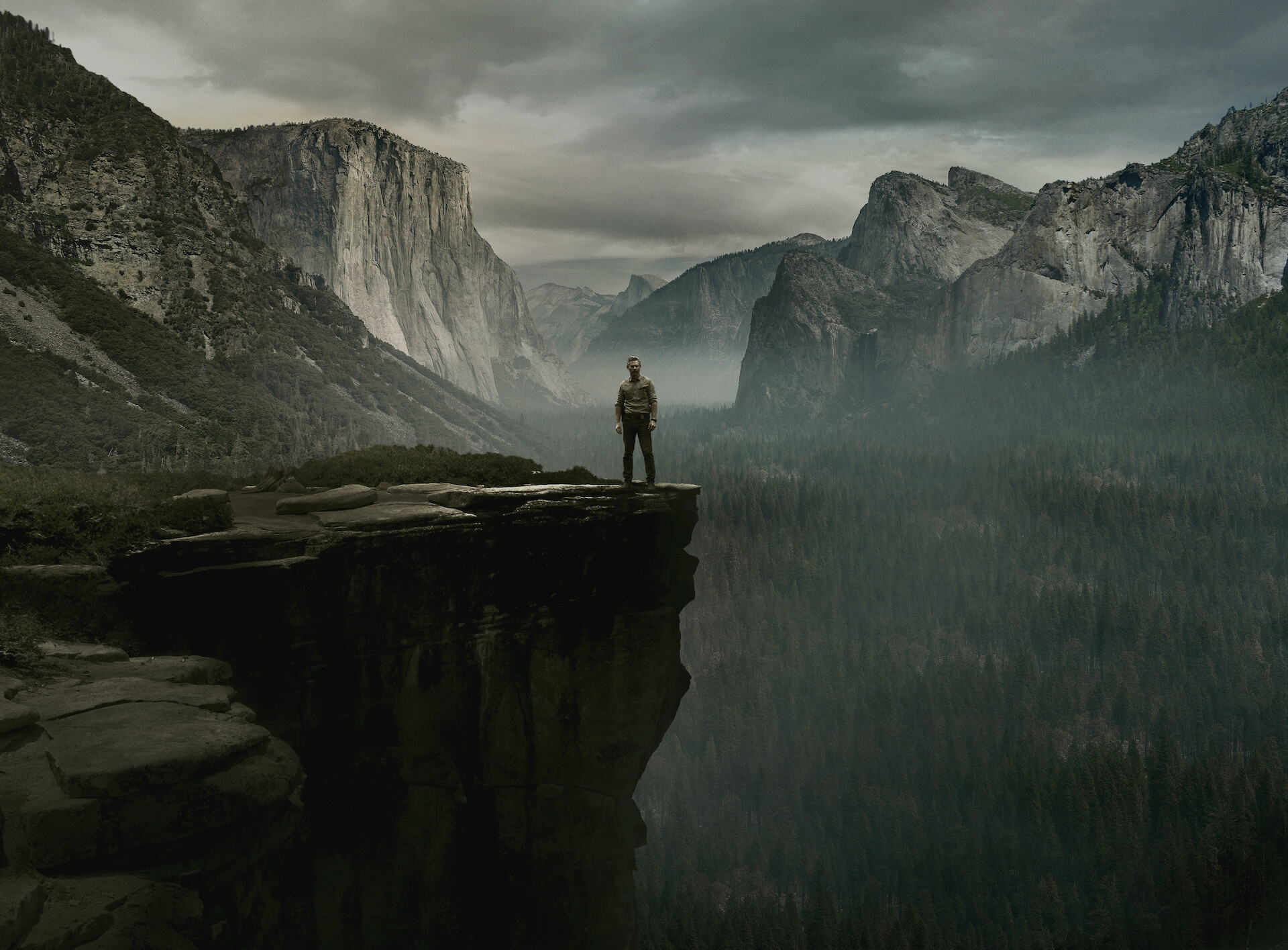 UNTAMED - a man standing on the edge of a cliff. 