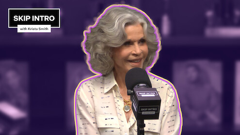 Jane Fonda sitting in front of a microphone, with the 'Skip Intro' logo positioned in the upper left corner.