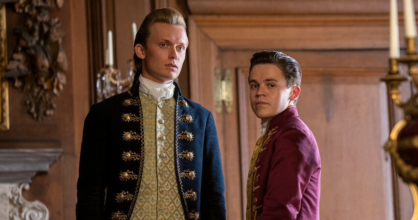 Reynolds and Brimsley stand next to each other in Queen Charlotte