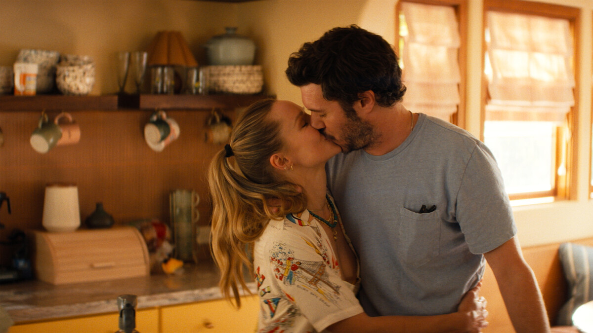 Kristen Bell as Joanne and Adam Brody as Noah kiss in their kitchen in Nobody Wants This Season 3