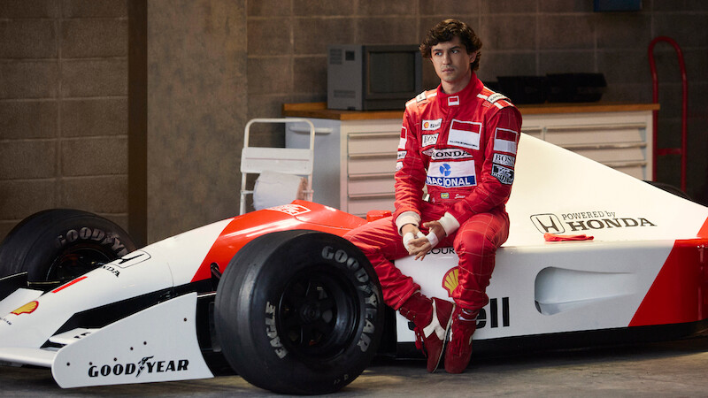 Gabriel Leone as Ayrton Senna sits on the side of his race car in 'Senna'
