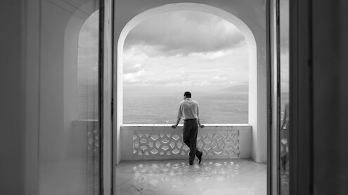Tom Ripley stares out at the sea