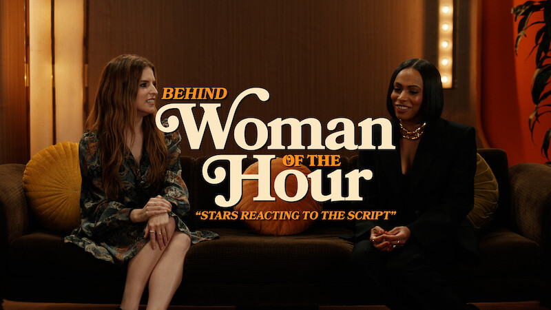 Anna Kendrick seated next to Nicolette Robinson on a sofa.