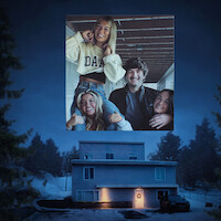 Four smiling young adults pose together indoors in a bright, casual setting; this photo appears as an overlay above a snowy, dusk-lit house surrounded by trees, with a warmly lit entrance and parked car.