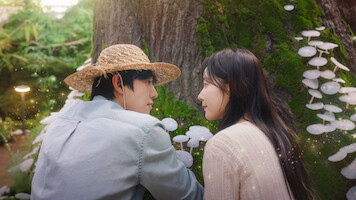 Ahn Hyo-seop as Matthew and and Chae Won-been as Ye-jin observe mushrooms in 'Sold Out on You.'