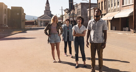 An image of the characters standing in the ghost town in Texas Chainsaw Massacre