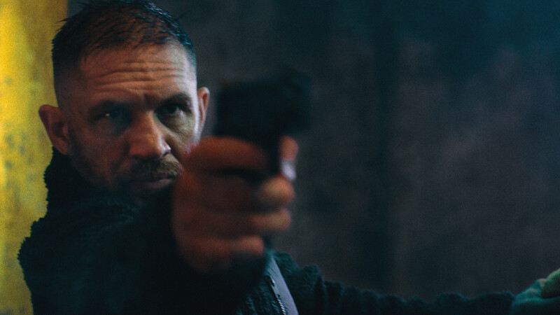 Tom Hardy holds a gun in 'HAVOC'