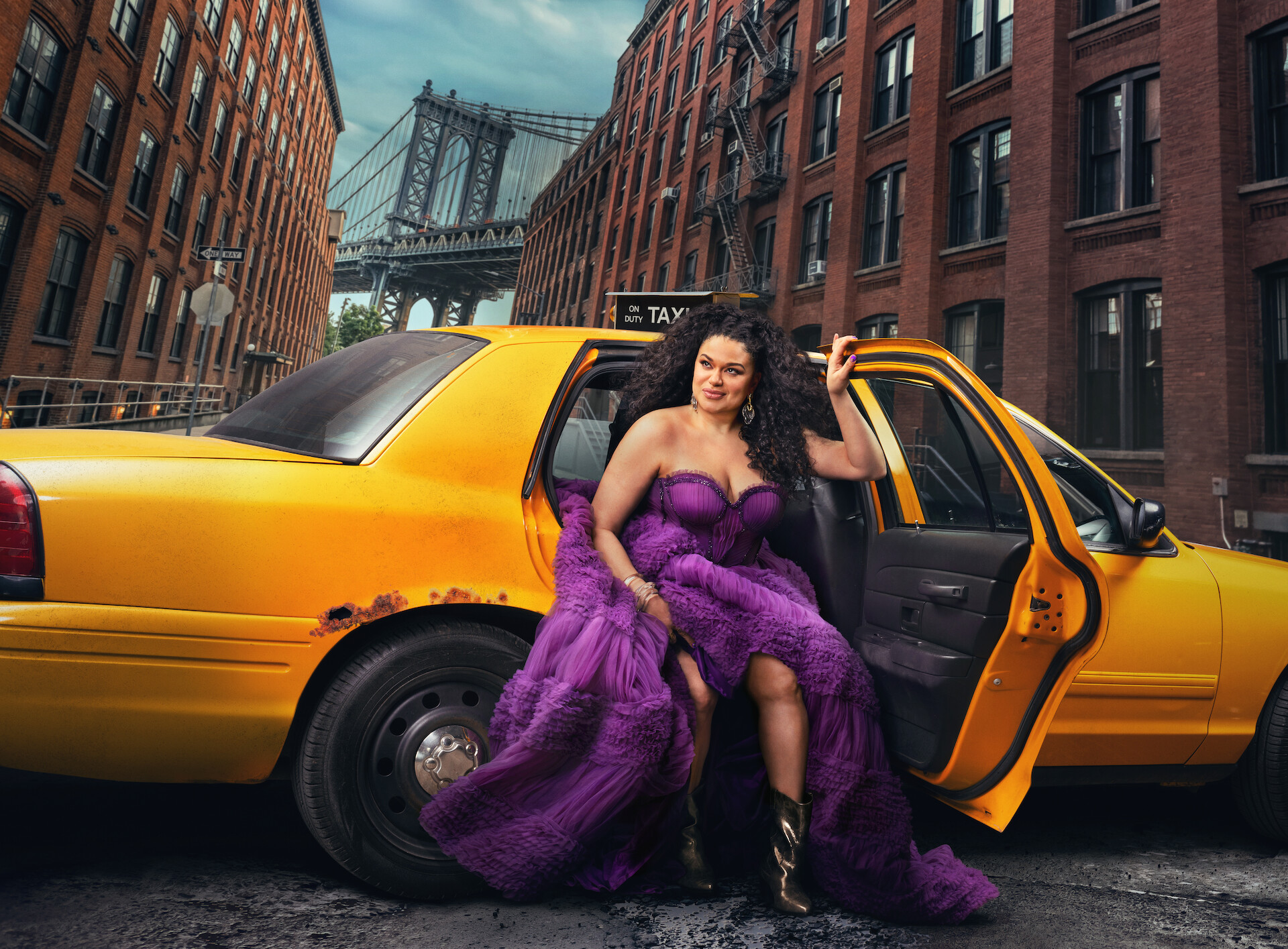 Survival of the Thickest key art - Michelle Buteau in a flowing purple dress stepping out of a taxi in NYC. 