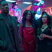 Three well-dressed people in a nightclub with neon lighting, looking intently ahead. Background features shirtless male performers on platforms and a lively crowd. The setting is vibrant and energetic.