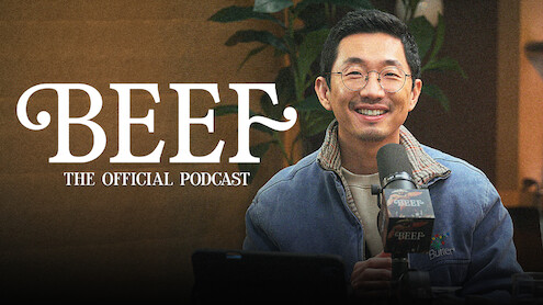 Lee Sung Jin sits at a podcast desk in front of a microphone, with a plant visible in the background. On-screen text reads: “BEEF: The Official Podcast.”