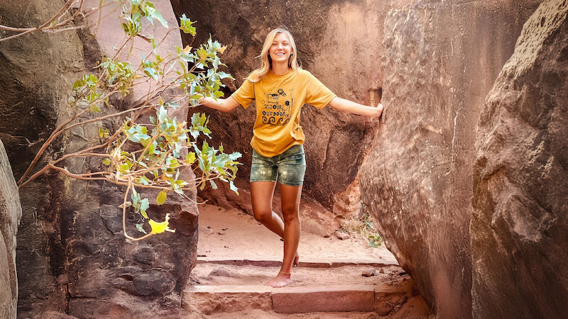A photograph of Gabby Petito posing on a trail. 