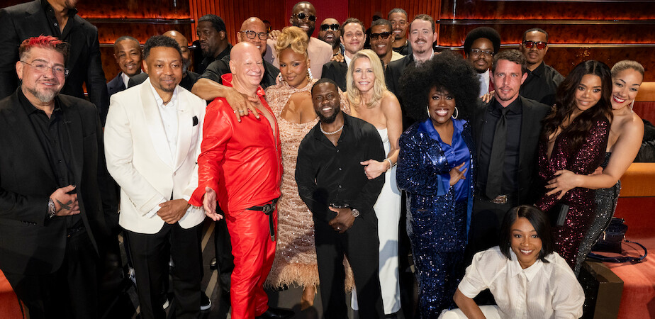 Big Jay Oakerson, Na'im Lynn, Jeff Ross, Dwayne Johnson, Lizzo, Draymond Green, Kevin Hart, Pete Davidson, Chelsea Handler, Shane Gillis, Sheryl Underwood, Tony Hinchcliffe, Tiffany Haddish, Regina Hall, dressed formally and colorfully.